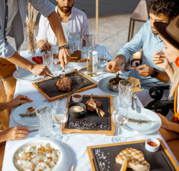 a group of people eating food at a table