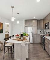 A modern kitchen with a dining table and chairs.
