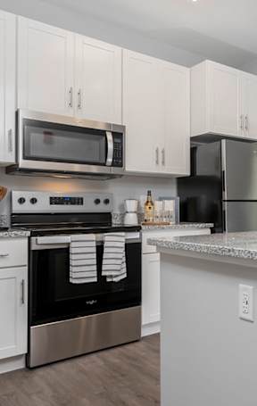 an open kitchen with a granite counter top and stools