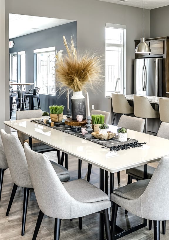 a dining room and kitchen with a marble table and chairs