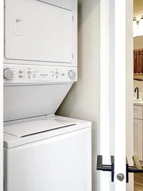 A white dishwasher and washing machine in a kitchen.