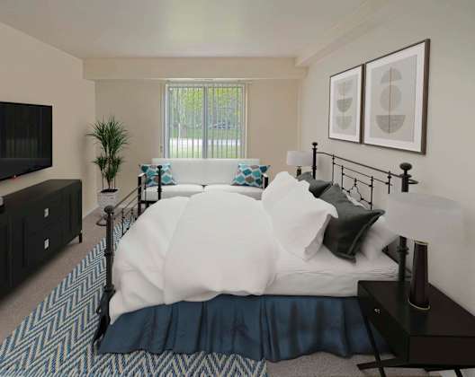 a bedroom with a bed and a tv