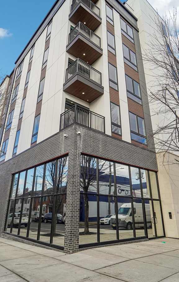 A tall building with a balcony on the top floor.