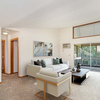 a furnished living room with high vaulted ceilings. Golden Valley, MN Valley View Apartments