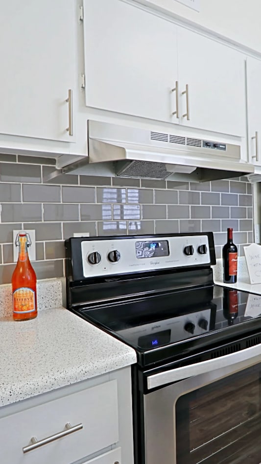 a kitchen with a washer and dryer and a table and a laundry room at Spring Meadow Apartments, Glendale, AZ, 85302