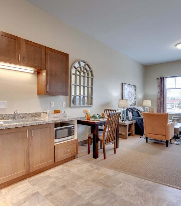 A bedroom with a bed, nightstand, and a ceiling fan.at Mountain Lakes Estates Apartments, Reno, Nevada