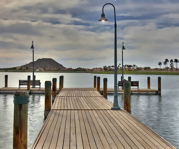 a dock on a lake with a light post