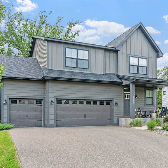 A modern house with a grey garage door.