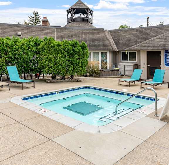 A pool with a blue sign in front of it.