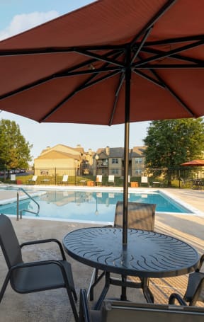 our apartments have a large swimming pool with tables and chairs
