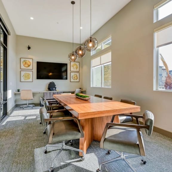 a large dining room with a wooden table and chairs