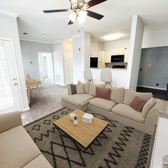 A living room with a beige sofa and a coffee table.