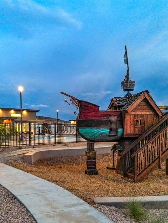 A playground with a wooden structure and a slide.