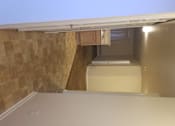 Thumbnail 6 of 41 - A room with a tiled wall and a window with blinds.
