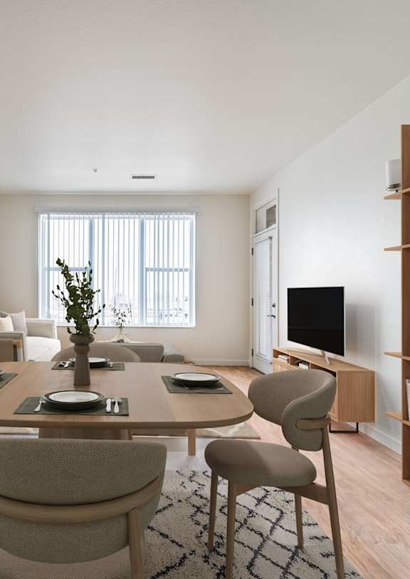 A dining room with a table set for six with a plant in the middle.
