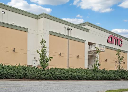Sugarloaf Mills- AMC movie theater with a blue sky and clouds in the background.