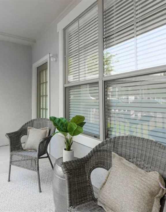 A balcony with a chair and a sofa. at Haven at Lewisville Lake Apartments, Lewisville, Florida