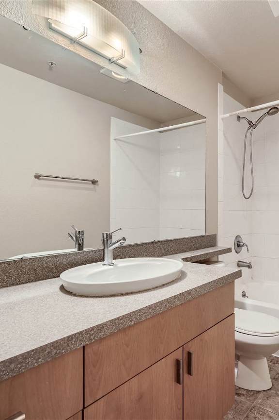 A bathroom with a sink, toilet, and bathtub.