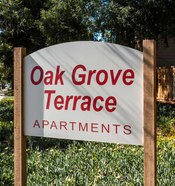 a sign that reads oak grove terrace apartments in Concord , Oak Grove Rd