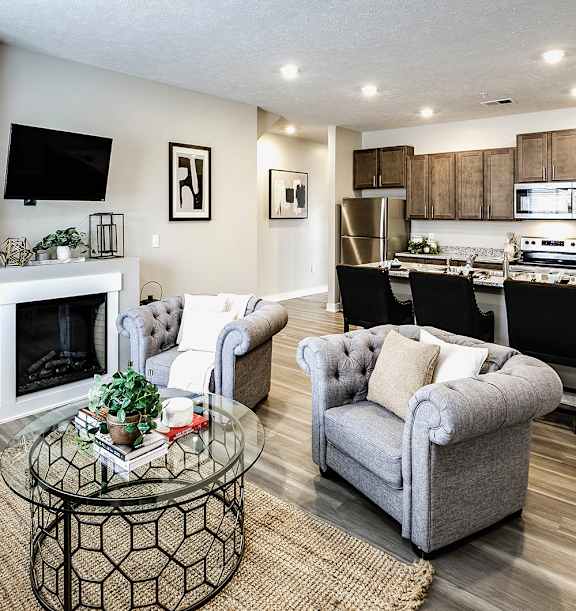 a living room with couches and chairs and a fireplace