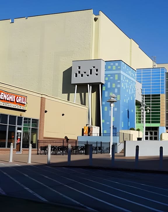 A street view of Legal Cinemas 16 with a clear sky above.
