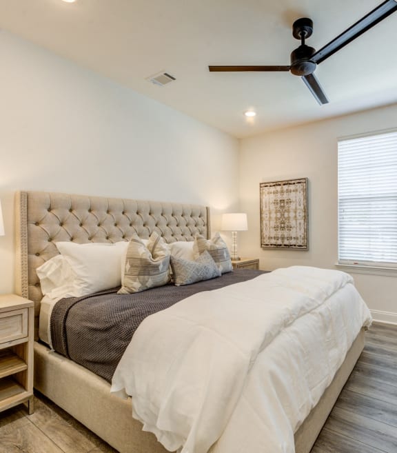 the master bedroom has a large bed and a ceiling fan at Residences at 393 North Apartments, Santa Rosa Beach, Florida