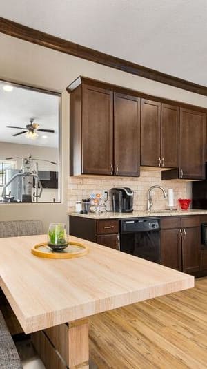 A kitchen with brown cabinets and a marble countertop.