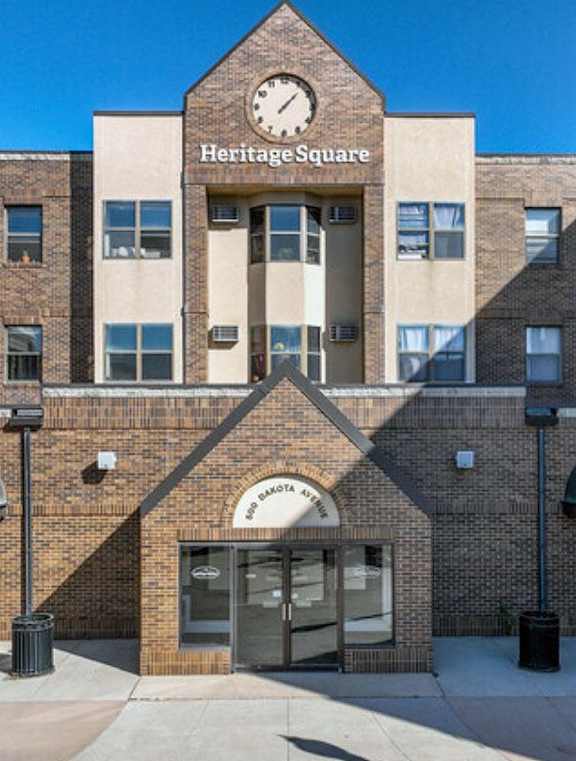 a brick building with a clock on the front of it