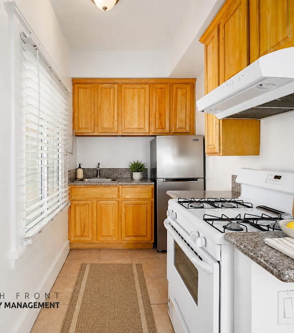 A well-lit, modern kitchen and living room with a dining area.