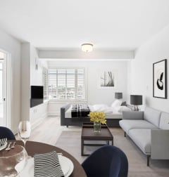 a living room with two couches and a rug and a dining room table