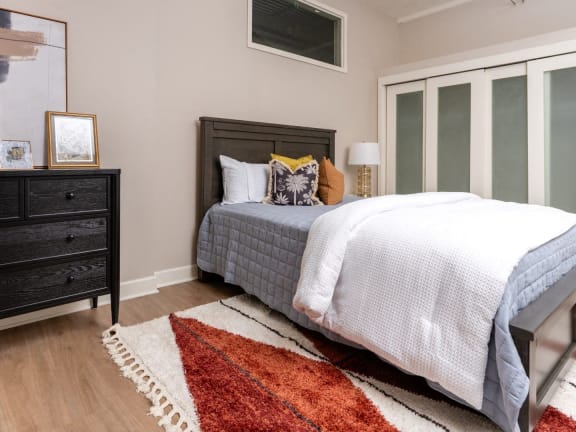 a bedroom with a bed and a dresser