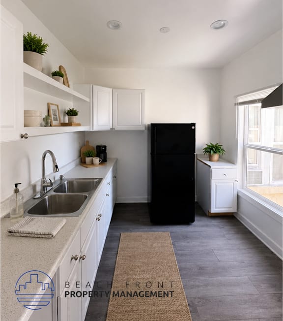 A well-lit, modern kitchen and living room with a dining area.