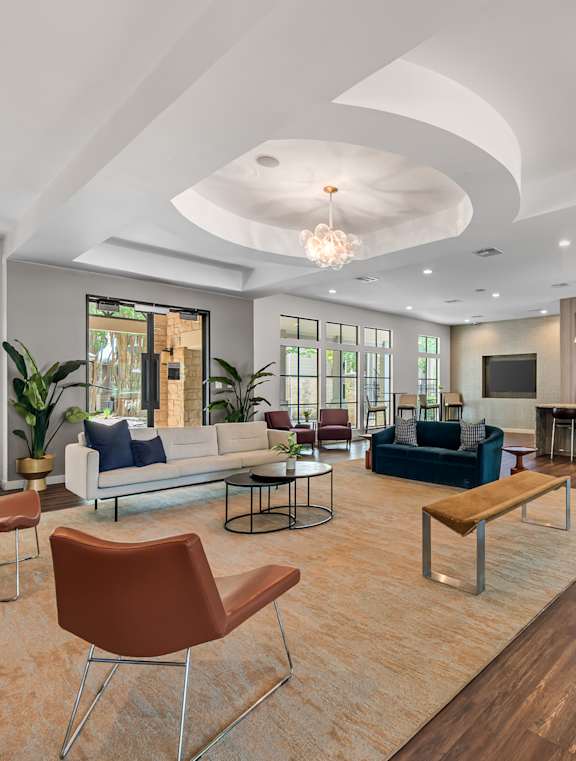A living room with a white ceiling and wooden floors.