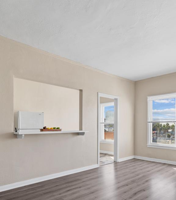 A well-lit, modern kitchen and living room with a dining area.
