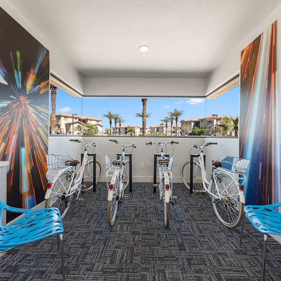 A room with a firework mural on the wall and bicycles parked in front of it.