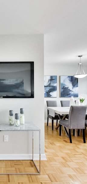 a living room and dining room with a table and chairs