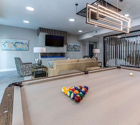 a large game room with a pool table and chairs at Tiffany Flats, Columbus, 43231