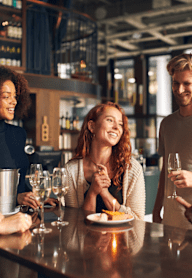 group of people at a bar talking and drinking wine at Connect on Northern Apartments, Glendale 85301