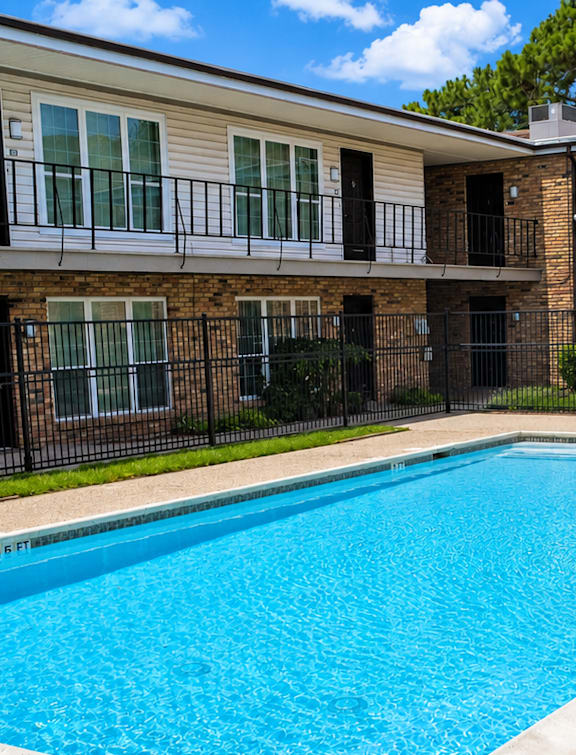 a swimming pool in front of an apartment building