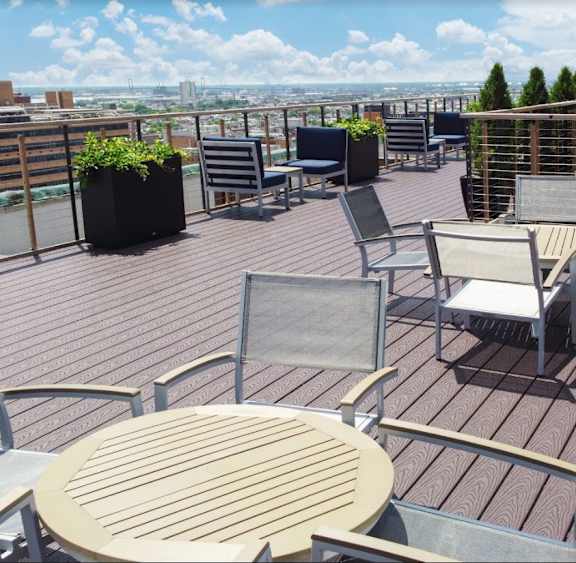 Tables and chairs set up on the Commownealth rooftop deck with panoramic views of downtown Philadelphia at The Commonwealth, Philadelphia, PA, 19107