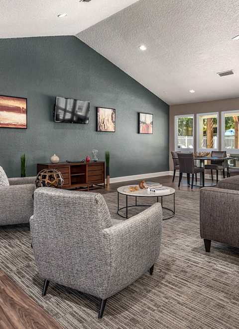 A living room with grey sofas and a wooden coffee table.