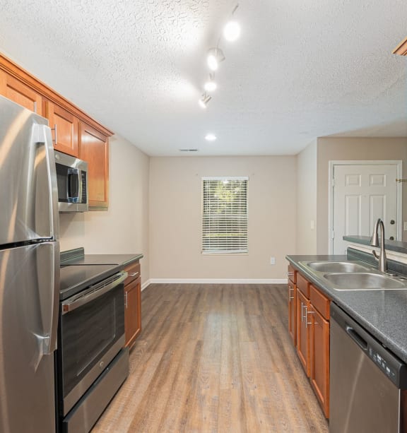 a kitchen with stainless steel appliances and wooden cabinets