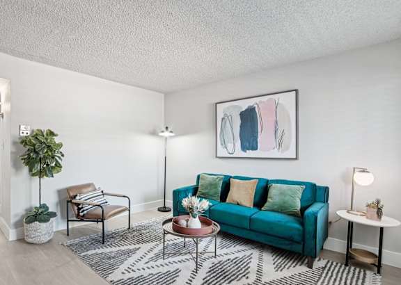 A living room with a green couch and a coffee table.