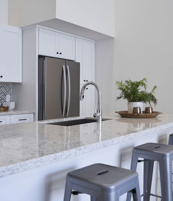 a kitchen with bar stools and a granite counter top at Novella Biltmore, Phoenix Arizona