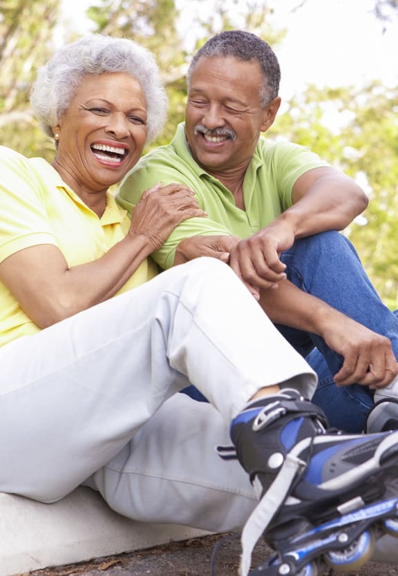 This is a photo of an older active couple roller blading.