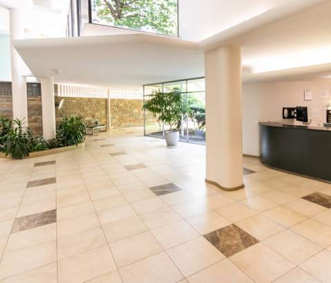 the lobby or reception area of a hotel with a reception desk