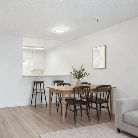A dining area with a table and chairs.