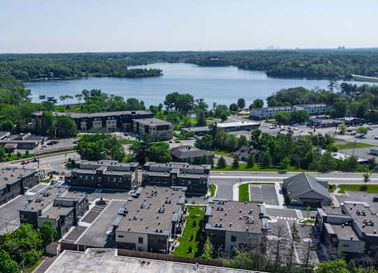 an aerial view of a city with a lake in the background