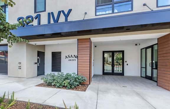 The front of a building with the name "ASANITY" on it.