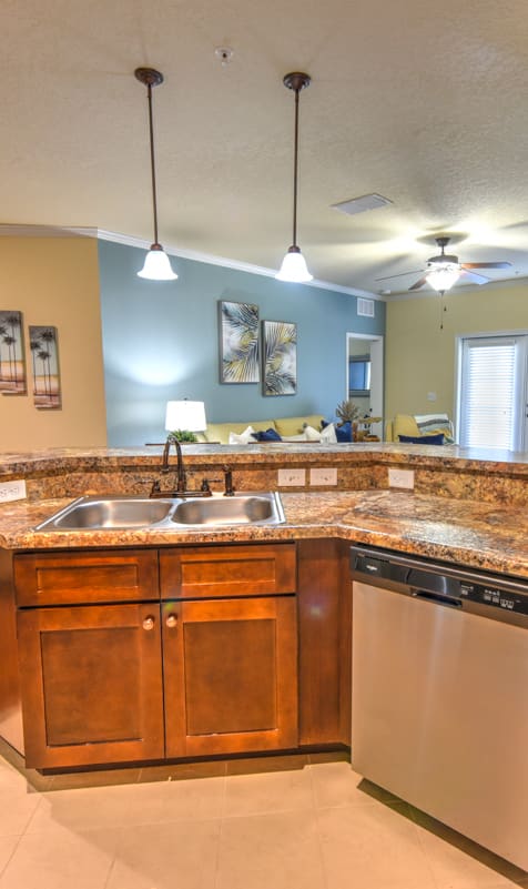 a kitchen with a sink and a dishwasher at Cabana Club Apartments in Jacksonville 32256